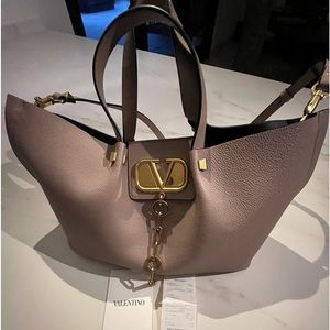 Valentino Garavani leather tote with attached red leather purse.